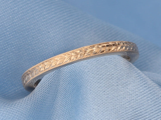 Yellow gold hand engraved wheat pattern band on fabric