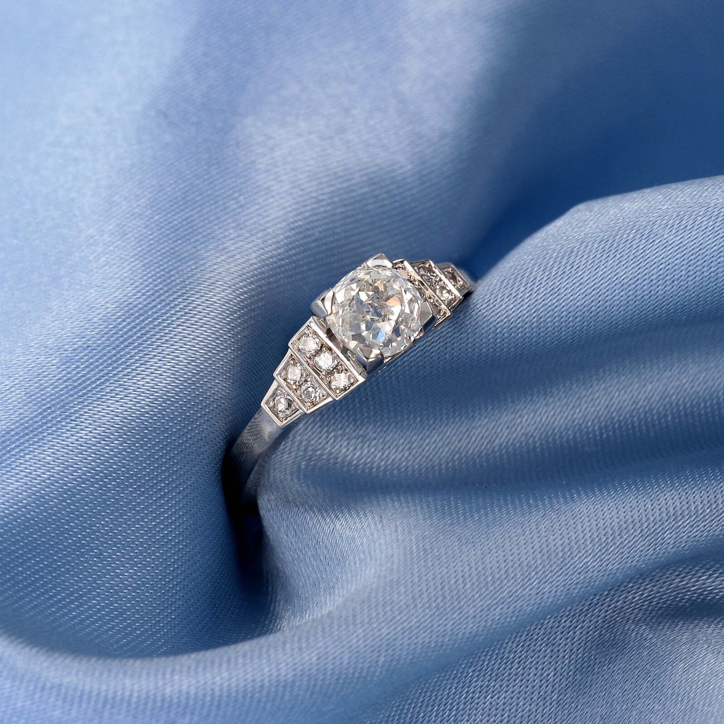 Platinum Geometric Art Deco Diamond Engagement Ring Replica on Blue Fabric