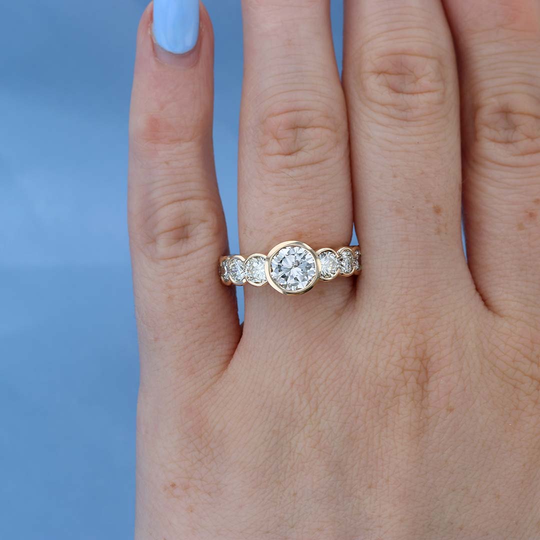 Bezel Set Eternity Diamond Engagement Ring on a Finger