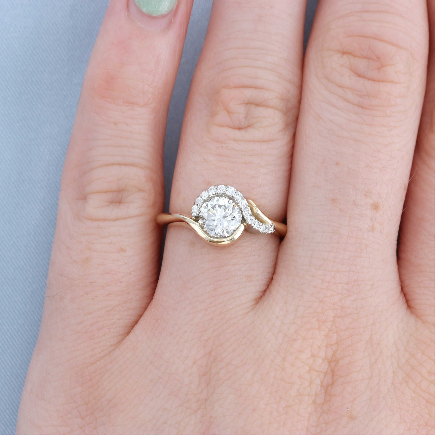 Swish Bypass Diamond Halo Engagement Ring on a Finger