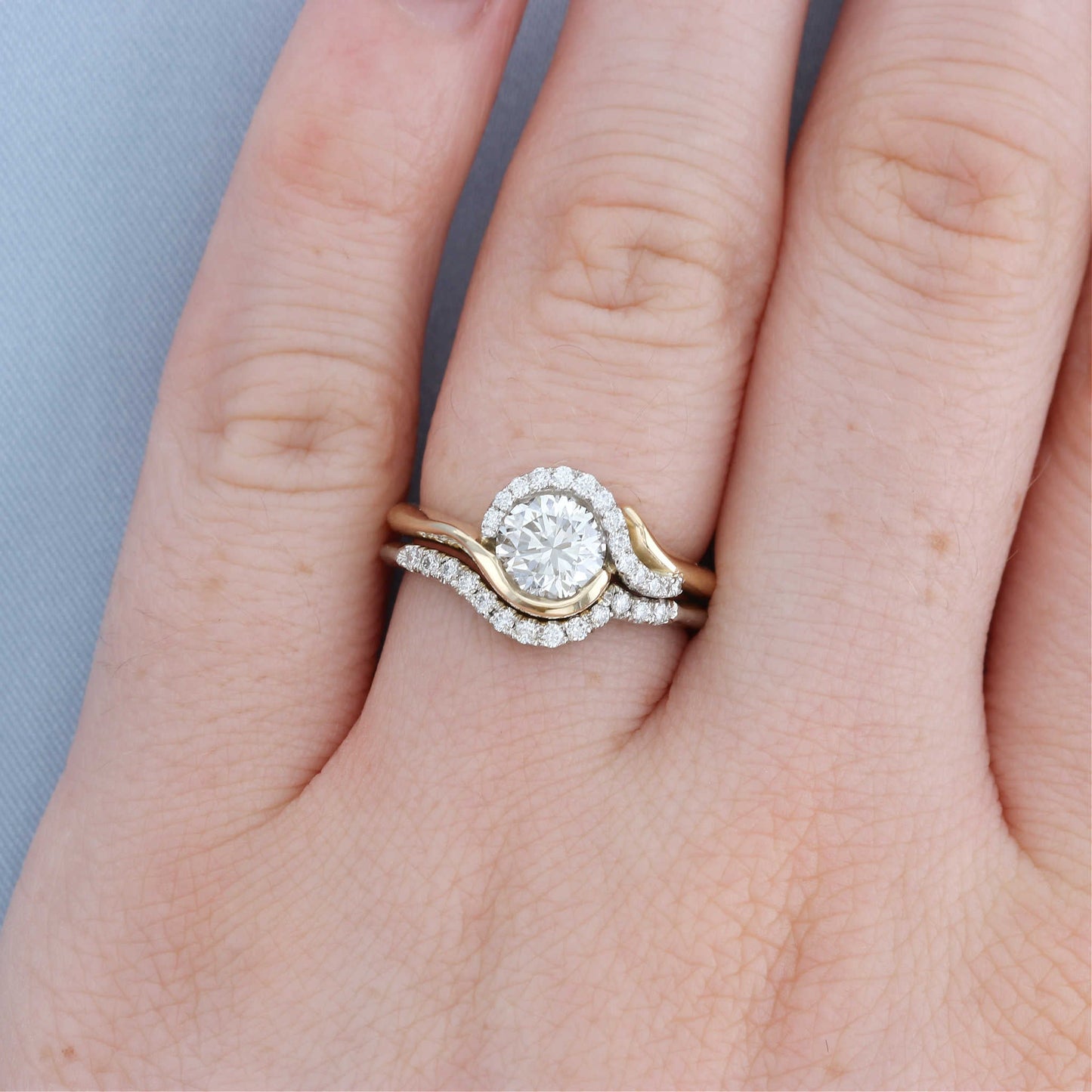 Swish Bypass Diamond Halo Engagement Ring on a Finger with Matching Shadow Band