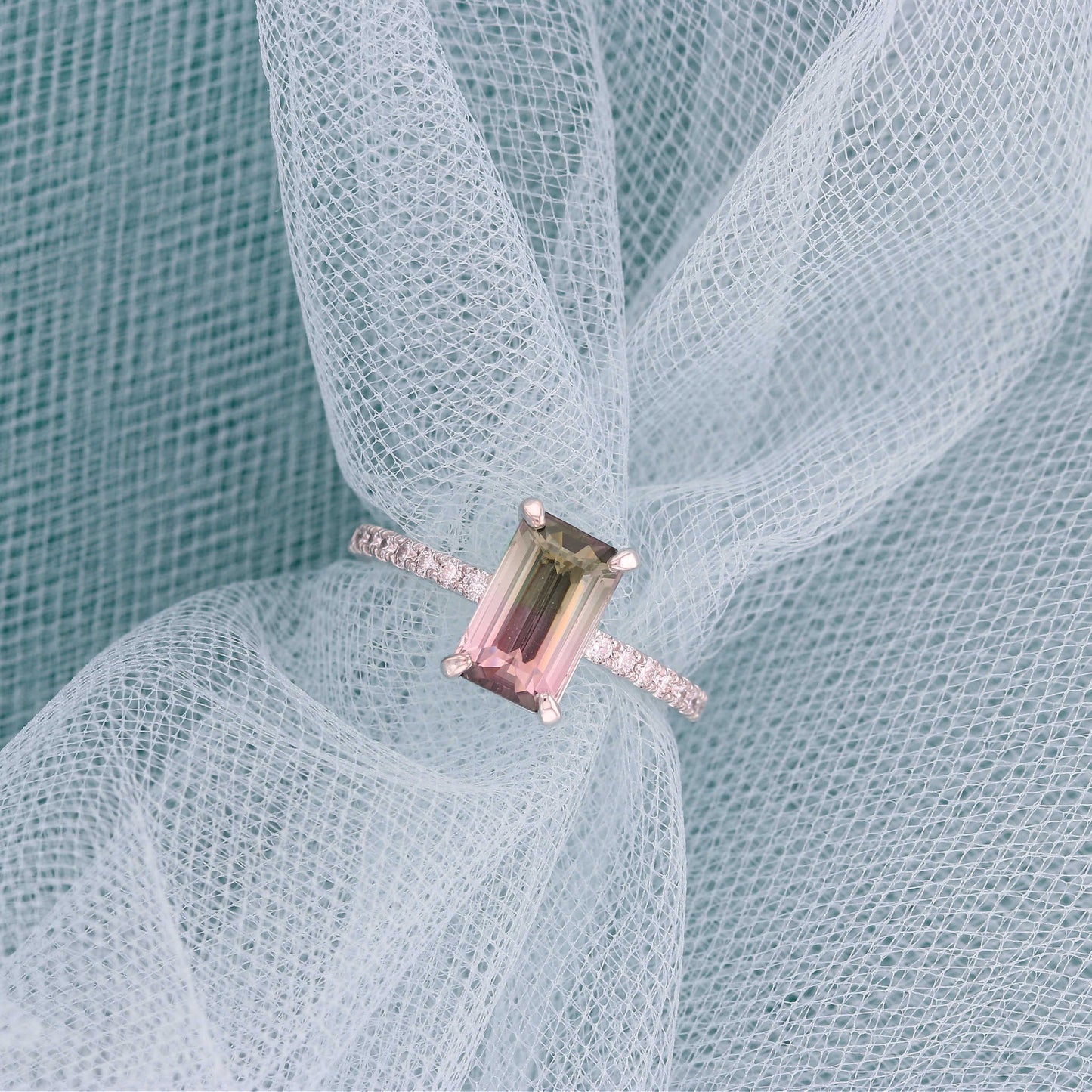 Emerald Cut Watermelon Tourmaline Engagement Ring on White Mesh Fabric