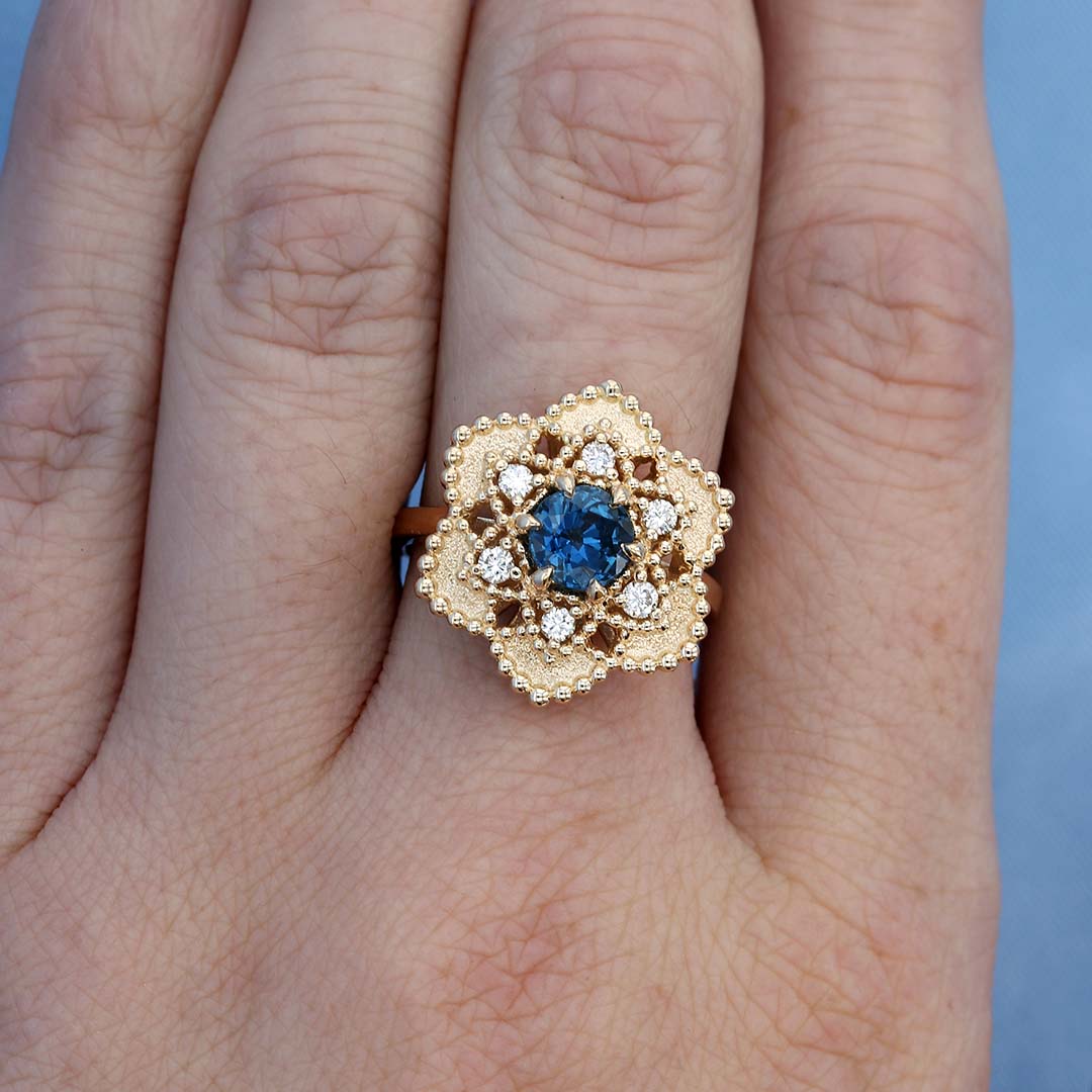 Sapphire & Diamond Flower Halo Ring on a Finger